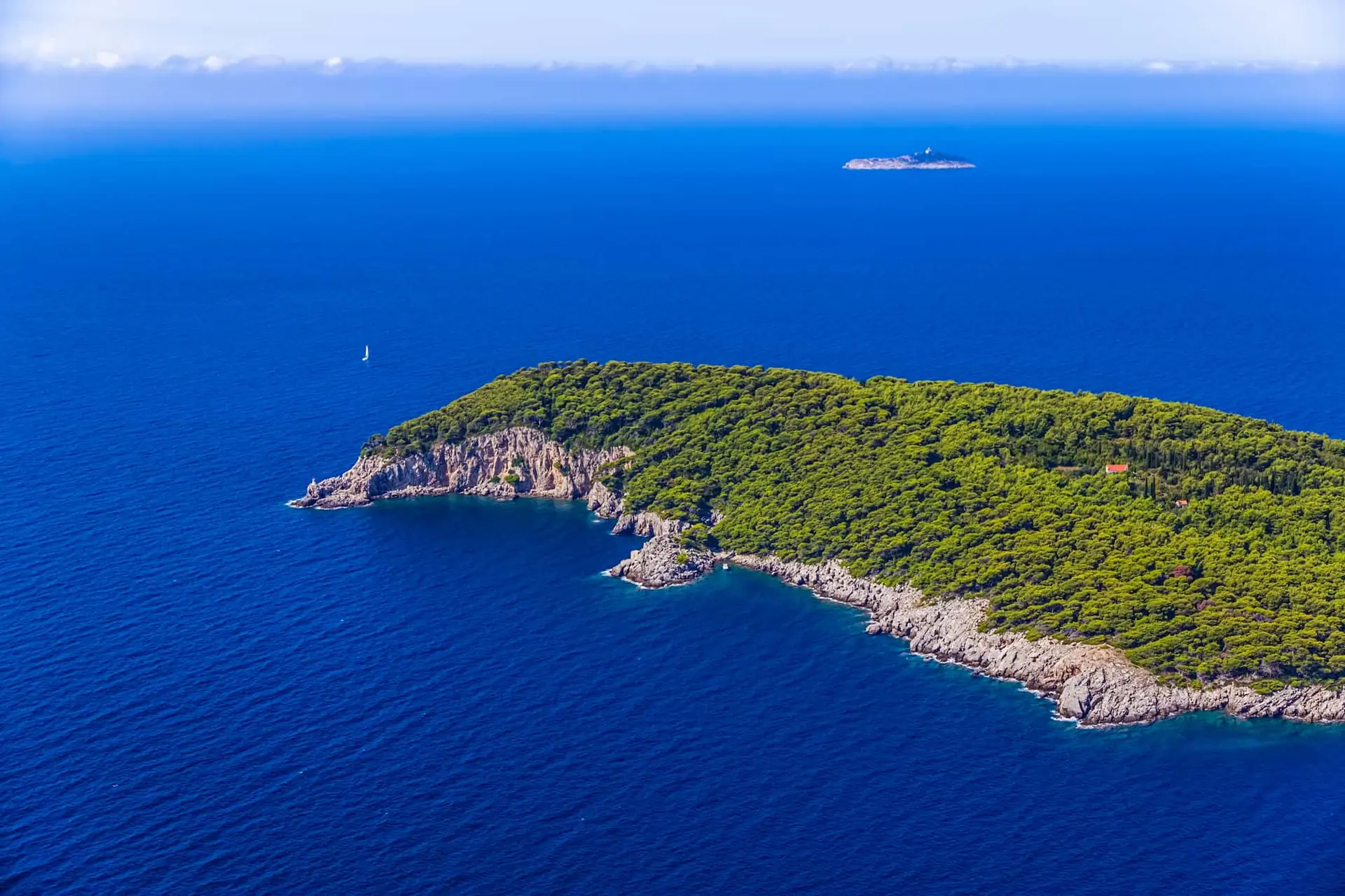 Pine-covered Elaphiti islands rising from calm turquoise water